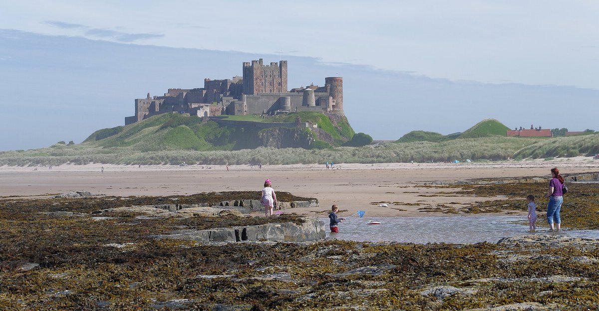 Bamburgh Castle seen from the beach at low tide