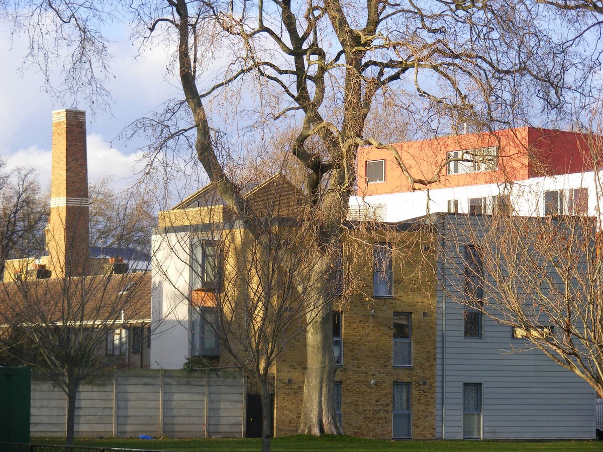 A Victorian mill and its tall brick chimney