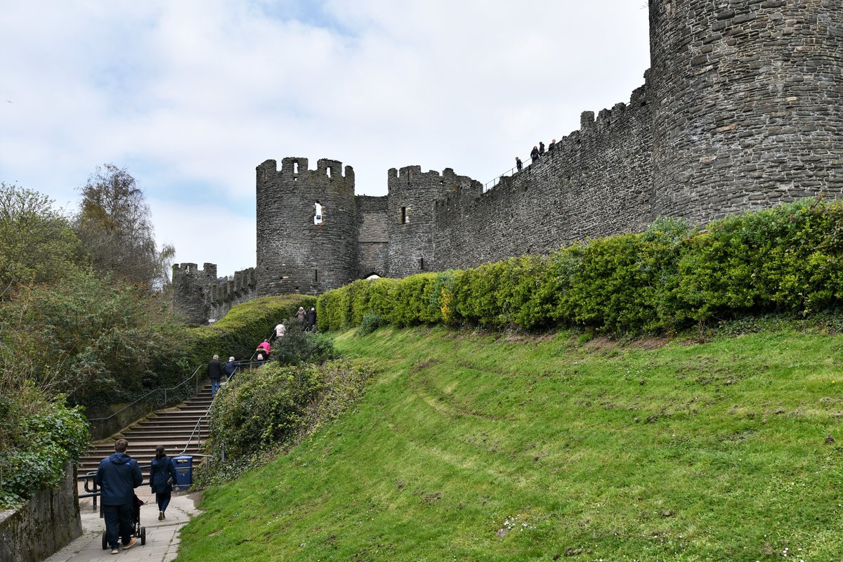 The medieval town walls of Conwy, with a wall tower, encircling the town