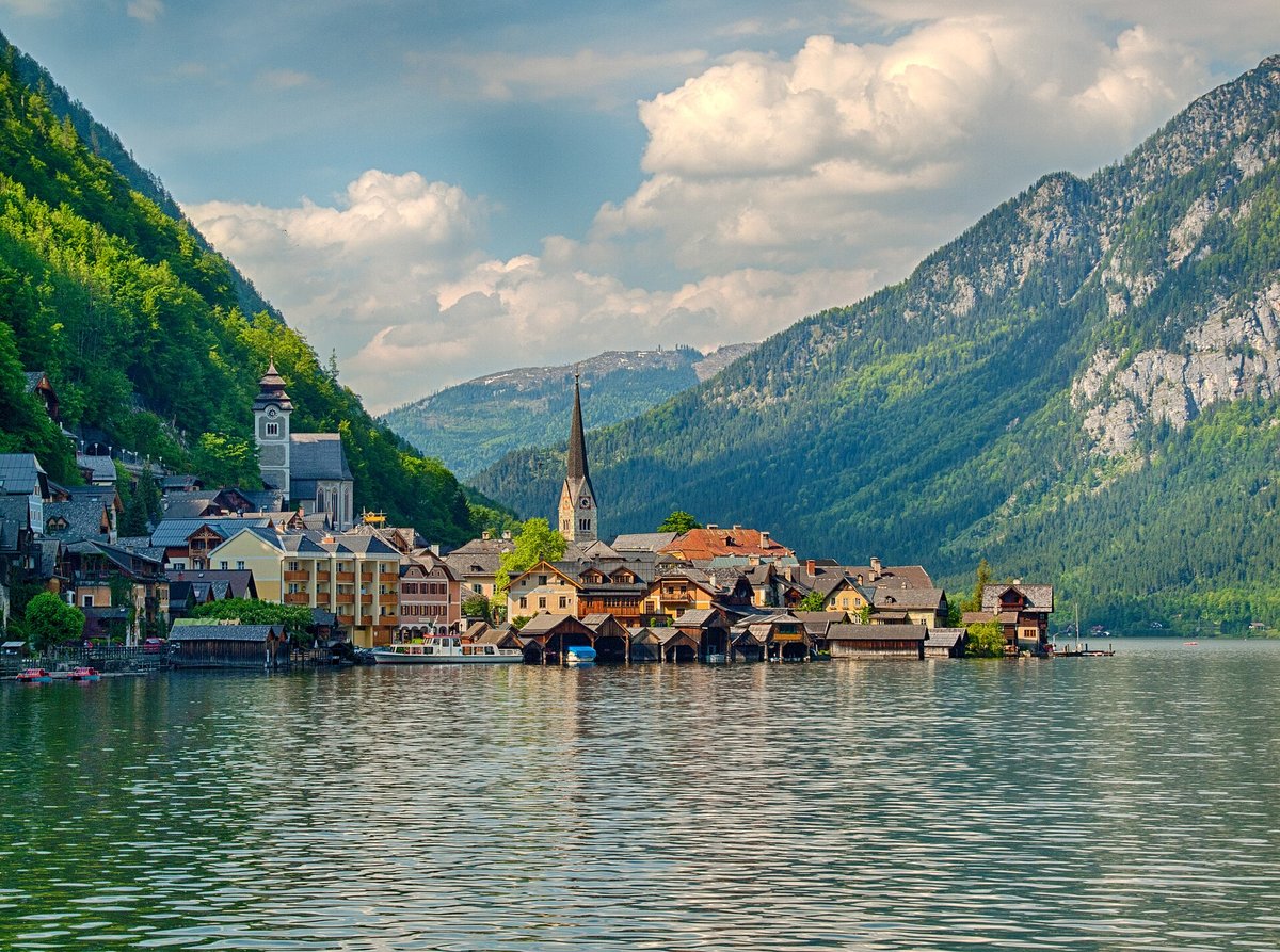 The village of Hallstatt reflected in its lake beneath the mountains