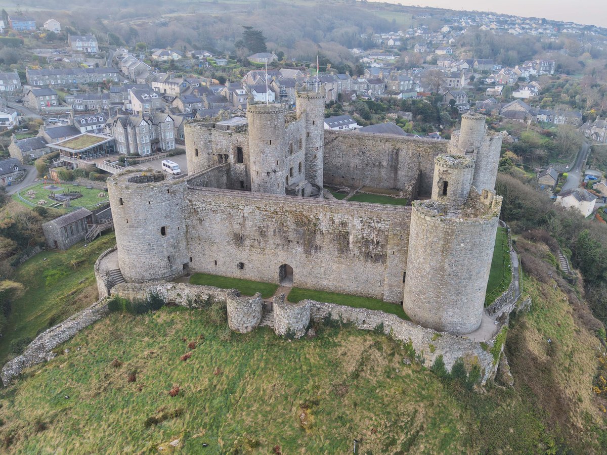 Aerial view of Harlech Castle showing its concentric plan, a castle within a castle, above the coastal plain