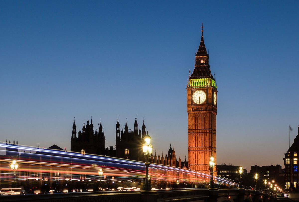 Big Ben and the Elizabeth Tower lit up at dusk over the Thames