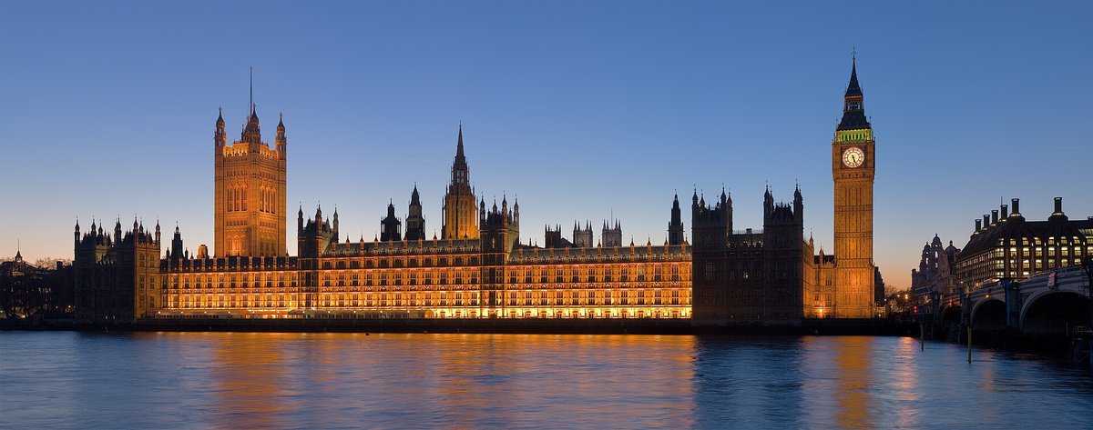 The Houses of Parliament and Big Ben at dusk from across the Thames
