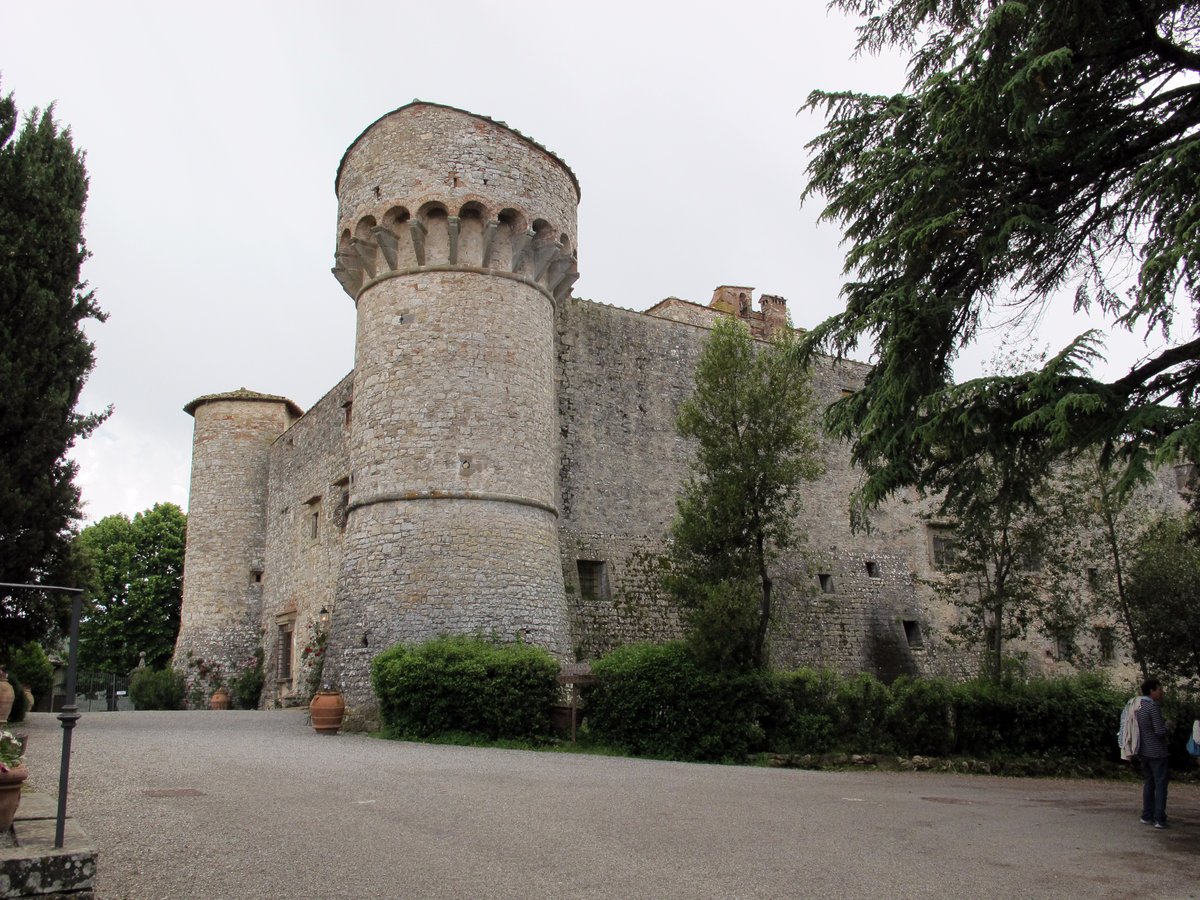 The Castello di Meleto in Gaiole in Chianti, its two cylindrical towers seen from the approach among cypresses
