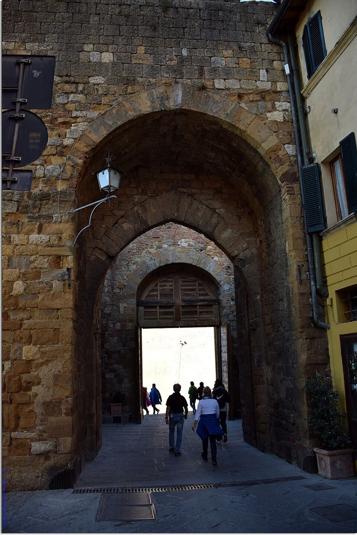 Looking through a stone gate arch in Montepulciano