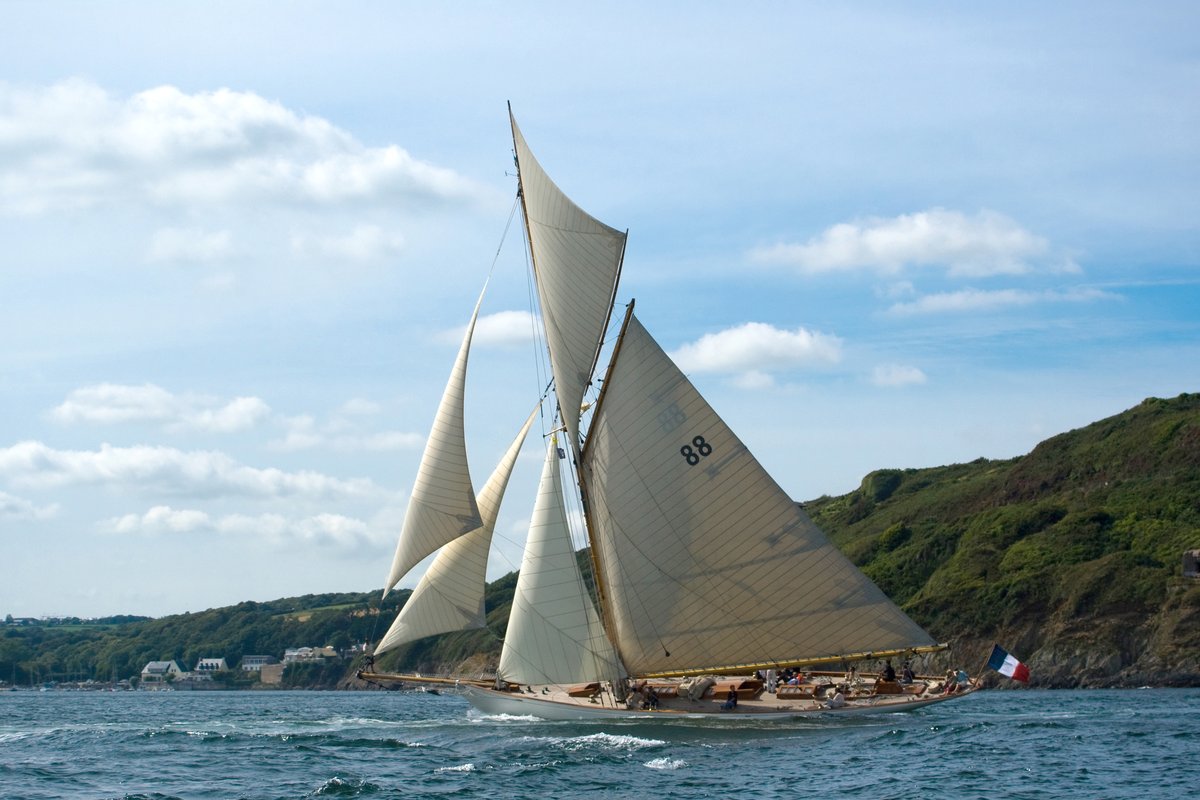 A big classic gaff cutter heeling to the wind during a classic yacht regatta