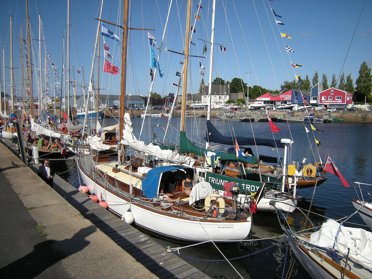 Classic wooden sailing yachts moored in a harbour