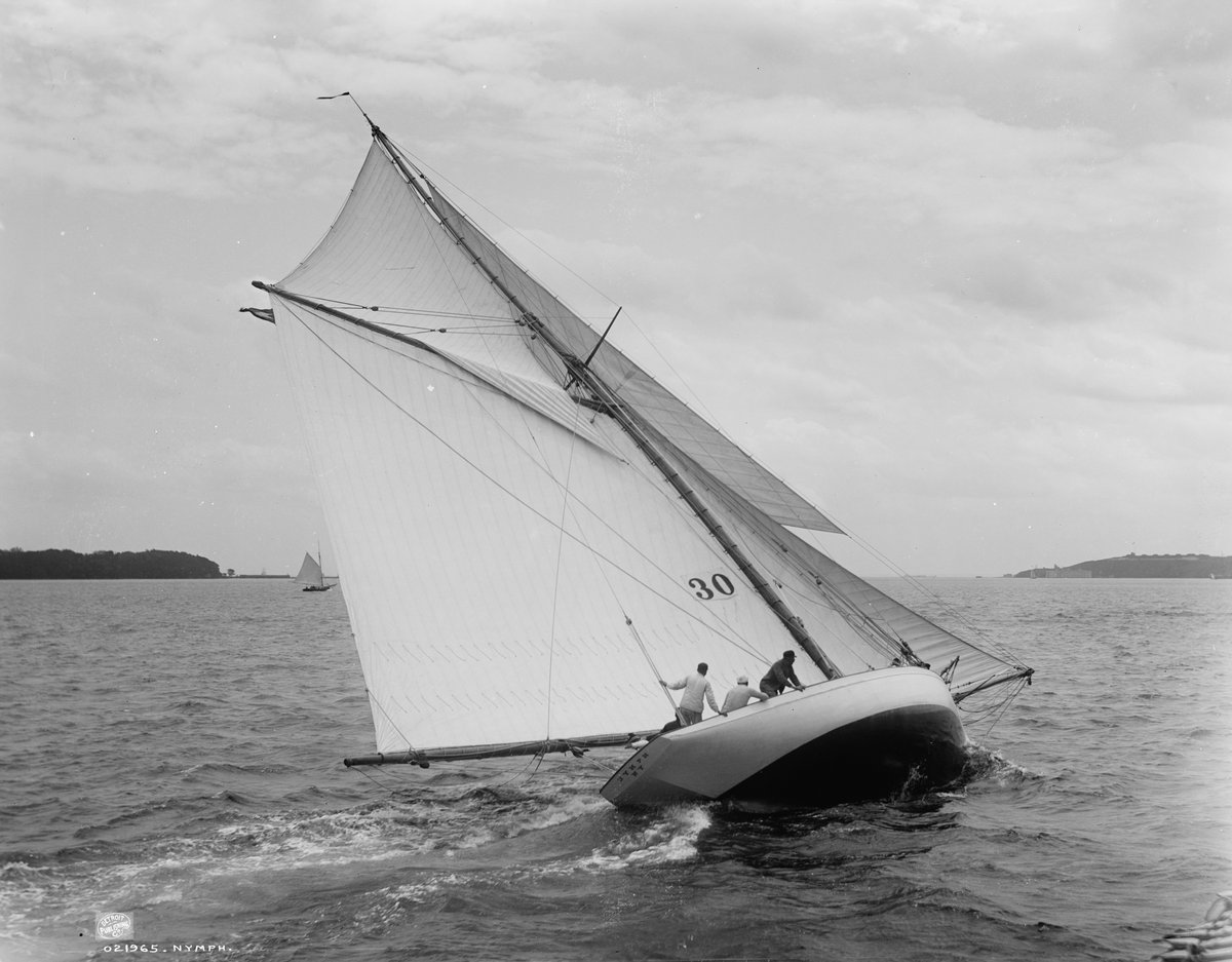 A classic gaff sloop heeling to the wind under full sail