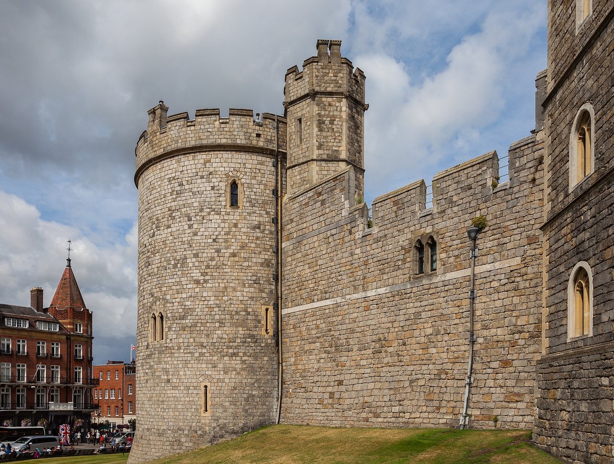 A tower of Windsor Castle against dramatic clouds