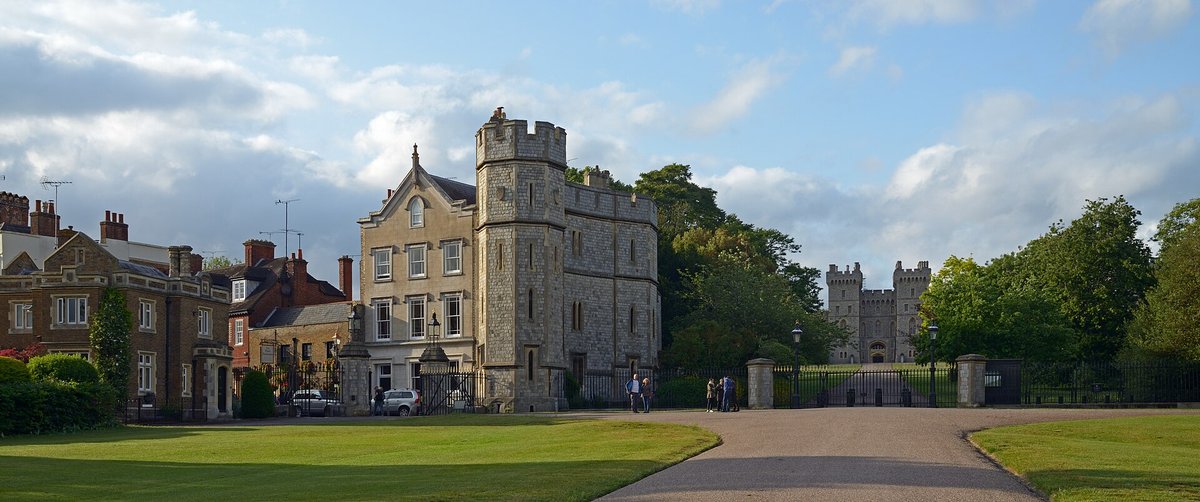 Windsor Castle seen at the far end of the Long Walk under a bright blue sky